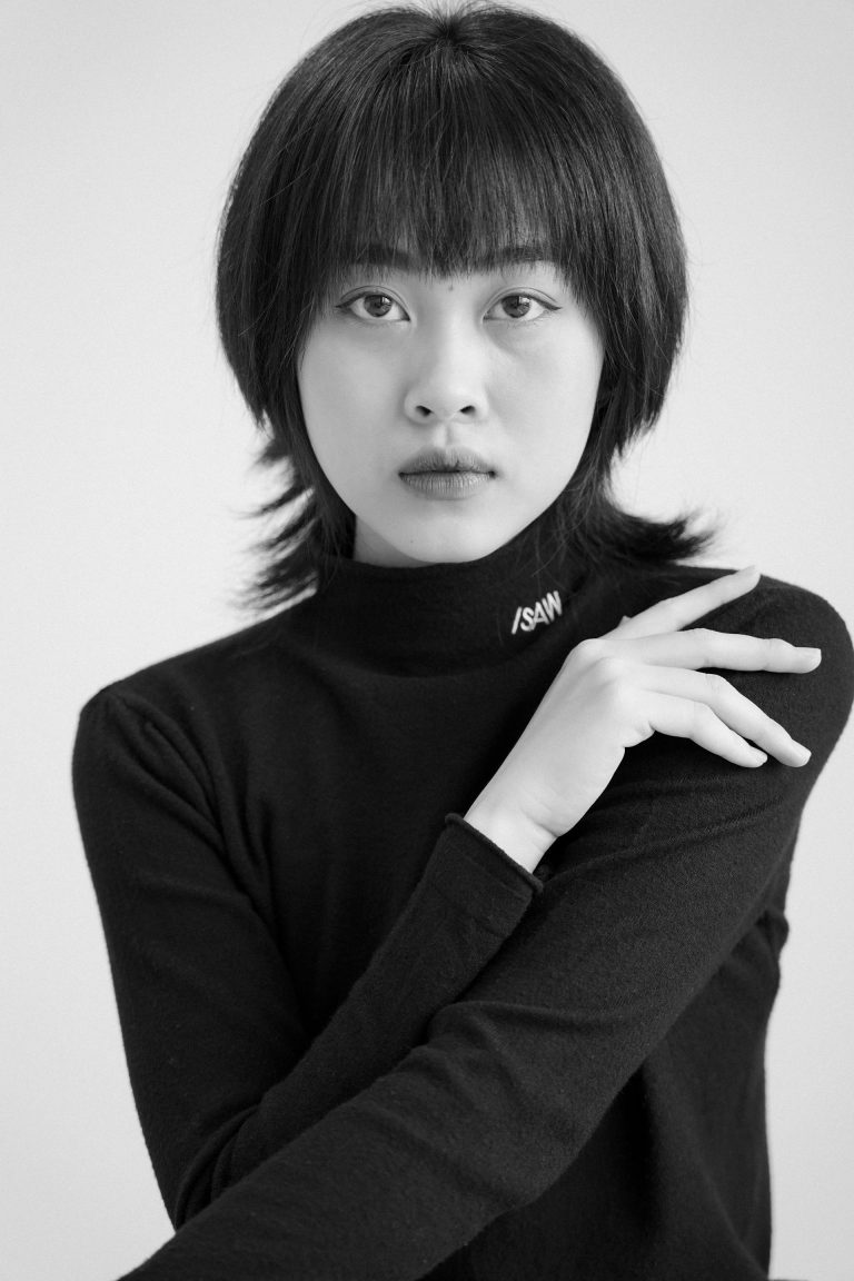 Portrait en noir et blanc d’une femme asiatique au regard neutre, symbolisant l’évaluation objective des comportements, motivations et talents naturels mesurés par le Profil Nova Global.